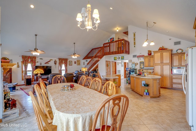 tiled dining area featuring high vaulted ceiling, a brick fireplace, and ceiling fan with notable chandelier