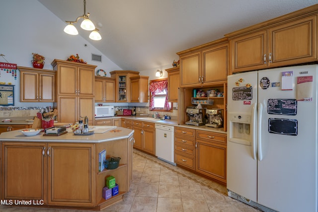 kitchen with hanging light fixtures, a kitchen island, light tile patterned flooring, sink, and white appliances