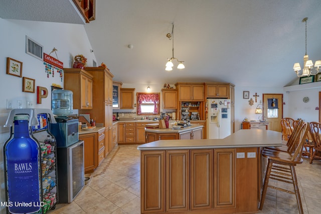 kitchen with white refrigerator with ice dispenser, a center island, vaulted ceiling, pendant lighting, and a notable chandelier