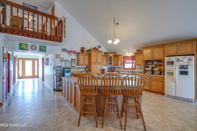 kitchen featuring high vaulted ceiling, white fridge with ice dispenser, a wealth of natural light, and light tile patterned flooring