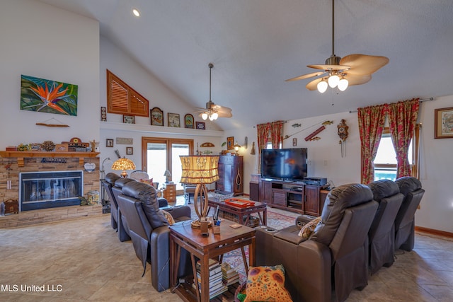 tiled living room featuring a wealth of natural light, a fireplace, and ceiling fan