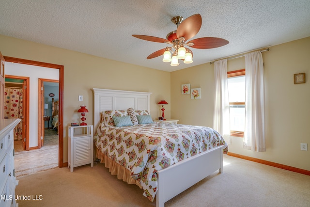 carpeted bedroom featuring a textured ceiling and ceiling fan