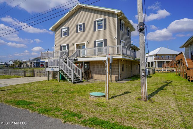 back of house featuring a yard and a deck