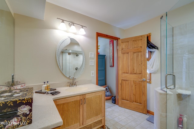 bathroom featuring vanity and an enclosed shower