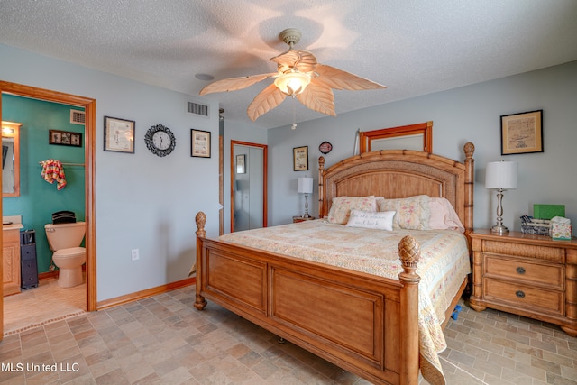 bedroom with connected bathroom, ceiling fan, and a textured ceiling