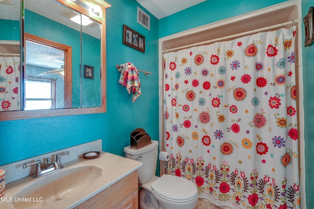 bathroom featuring toilet, a textured ceiling, vanity, and a shower with shower curtain