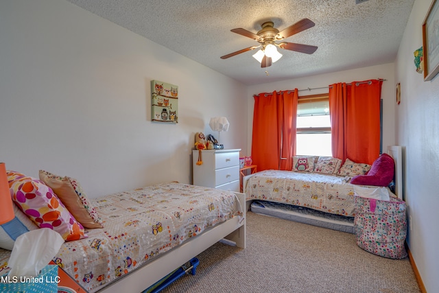 bedroom featuring ceiling fan, a textured ceiling, and carpet floors