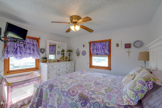 bedroom with a textured ceiling and ceiling fan