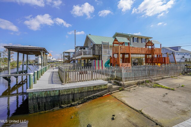 dock area featuring a deck with water view