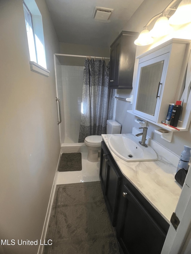 full bathroom with vanity, baseboards, toilet, a shower stall, and visible vents