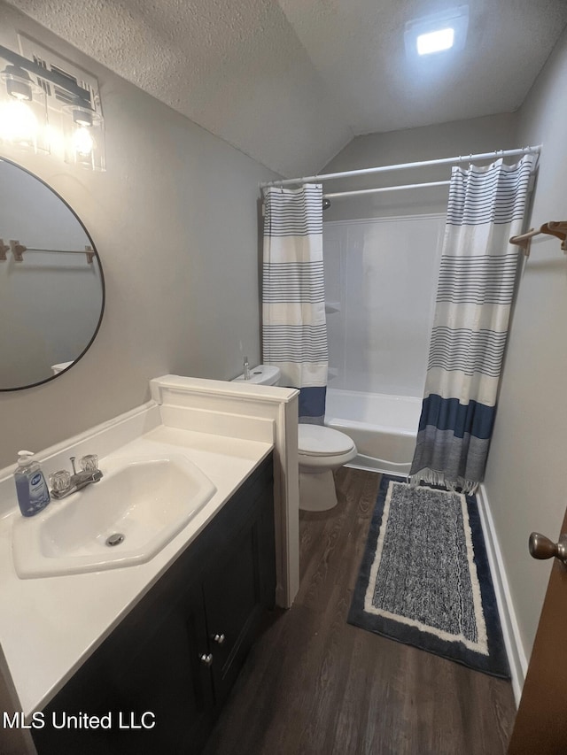 bathroom with a textured ceiling, vanity, toilet, shower / bath combo, and wood finished floors