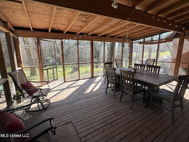 unfurnished sunroom with outdoor dining area