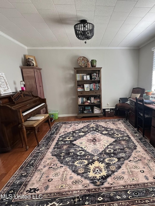 sitting room with crown molding, baseboards, and wood finished floors