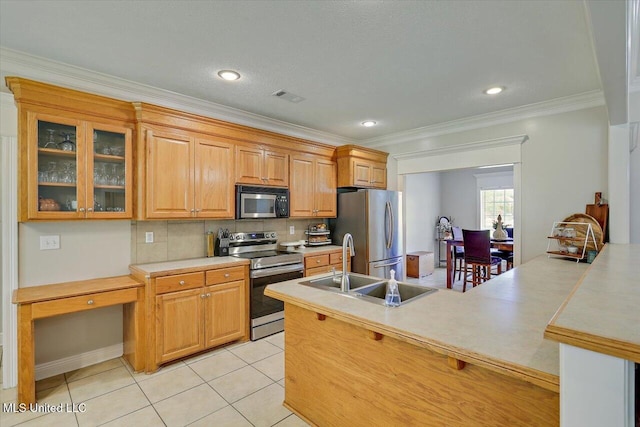 213 Pecan Cir, Brandon, MS 39042 - kitchen featuring stainless steel appliances, glass insert cabinets, light countertops, ornamental molding, and tasteful backsplash