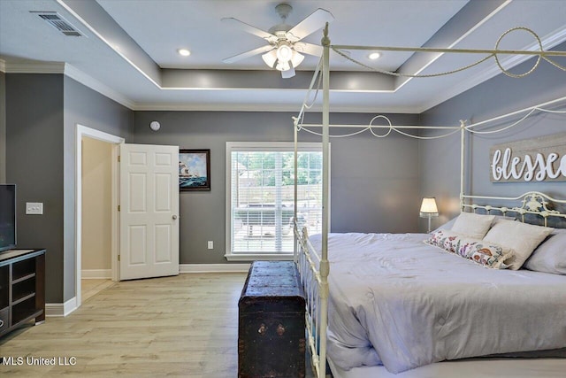 213 Pecan Cir, Brandon, MS 39042 - bedroom with baseboards, wood finished floors, crown molding, recessed lighting, and a tray ceiling