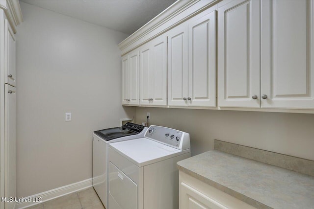 213 Pecan Cir, Brandon, MS 39042 - laundry room with cabinet space, washer and clothes dryer, baseboards, and light tile patterned flooring