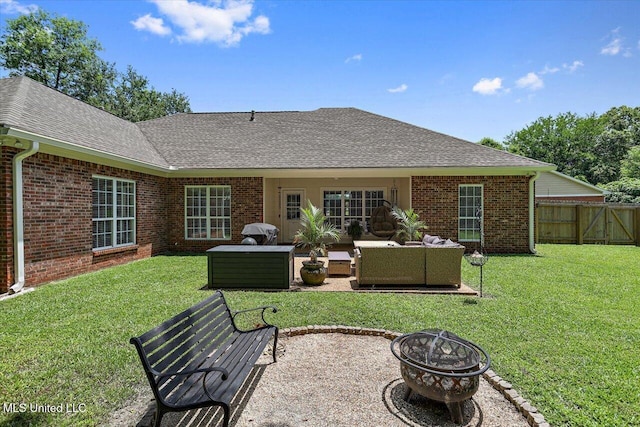 213 Pecan Cir, Brandon, MS 39042 - back of property featuring brick siding, a shingled roof, and an outdoor living space with a fire pit