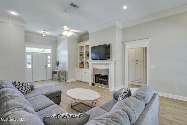 213 Pecan Cir, Brandon, MS 39042 - living room featuring ornamental molding, light wood finished floors, baseboards, ceiling fan, and a fireplace