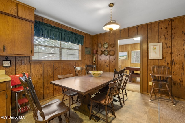 dining room with wooden walls