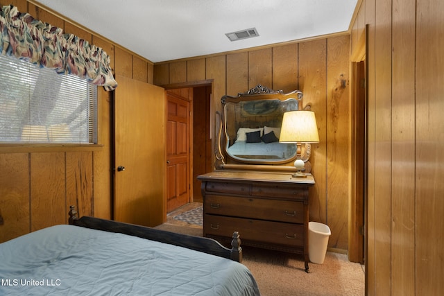 carpeted bedroom with wooden walls