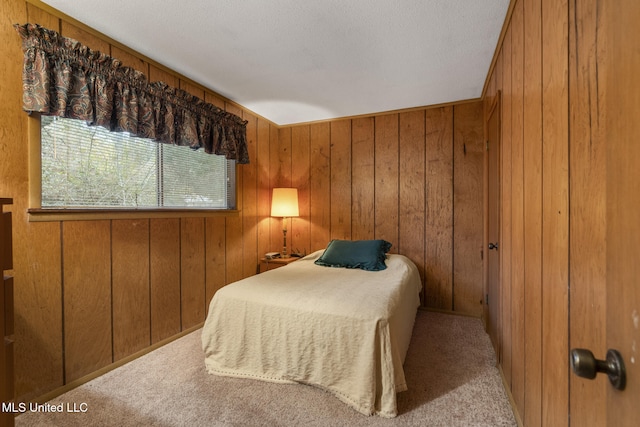 bedroom featuring light carpet and wood walls