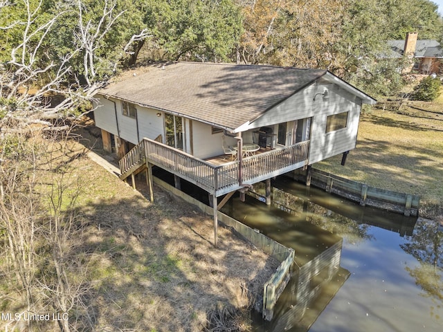 rear view of house featuring a water view