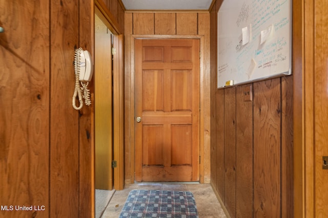 doorway with wooden walls