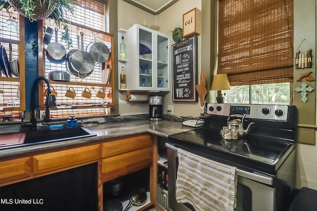1728 21st St, Gulfport, MS 39501 - kitchen with electric stove, a sink, healthy amount of natural light, and glass insert cabinets