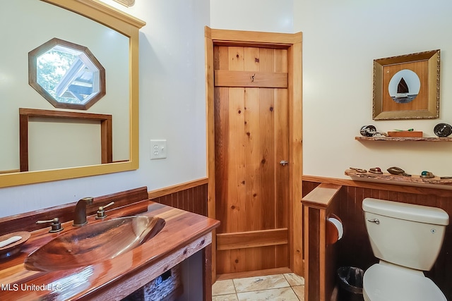 1728 21st St, Gulfport, MS 39501 - bathroom with toilet, a wainscoted wall, wood walls, and vanity