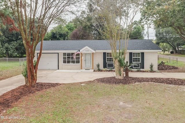 ranch-style home featuring a front lawn and a garage