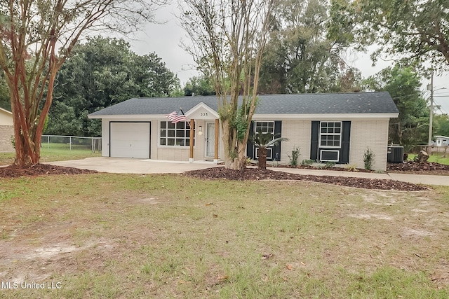 ranch-style home with a garage, a front lawn, and central air condition unit