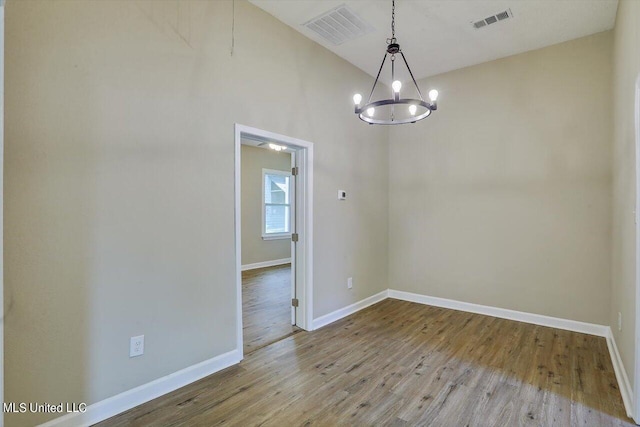 1204 Jackson St, Vicksburg, MS 39183 - unfurnished dining area featuring visible vents, wood finished floors, and a notable chandelier