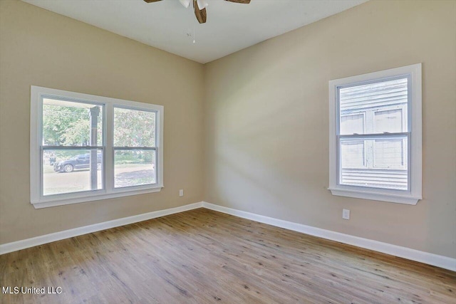 1204 Jackson St, Vicksburg, MS 39183 - empty room with wood finished floors, baseboards, and ceiling fan