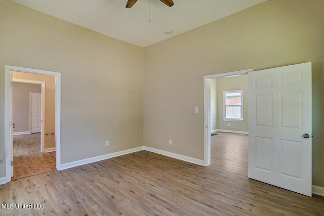 1204 Jackson St, Vicksburg, MS 39183 - empty room with baseboards, wood finished floors, and a ceiling fan