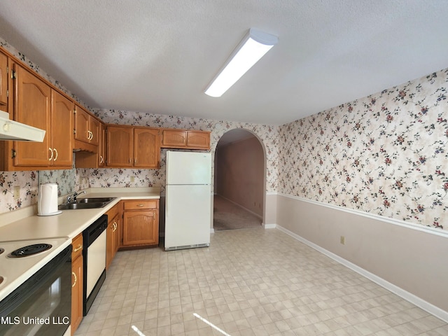 kitchen featuring a textured ceiling, sink, and white appliances