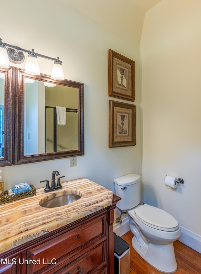 729 N Pearl St, Natchez, MS 39120 - bathroom featuring toilet, vanity, baseboards, and wood finished floors