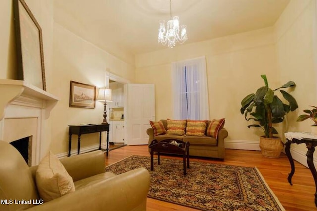 729 N Pearl St, Natchez, MS 39120 - living area with a chandelier, wood finished floors, and baseboards