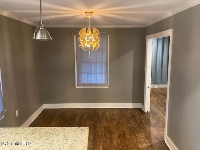 unfurnished dining area with ornamental molding and dark wood-type flooring