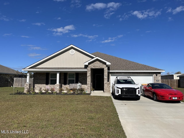 view of front of property with a garage, a front lawn, and covered porch