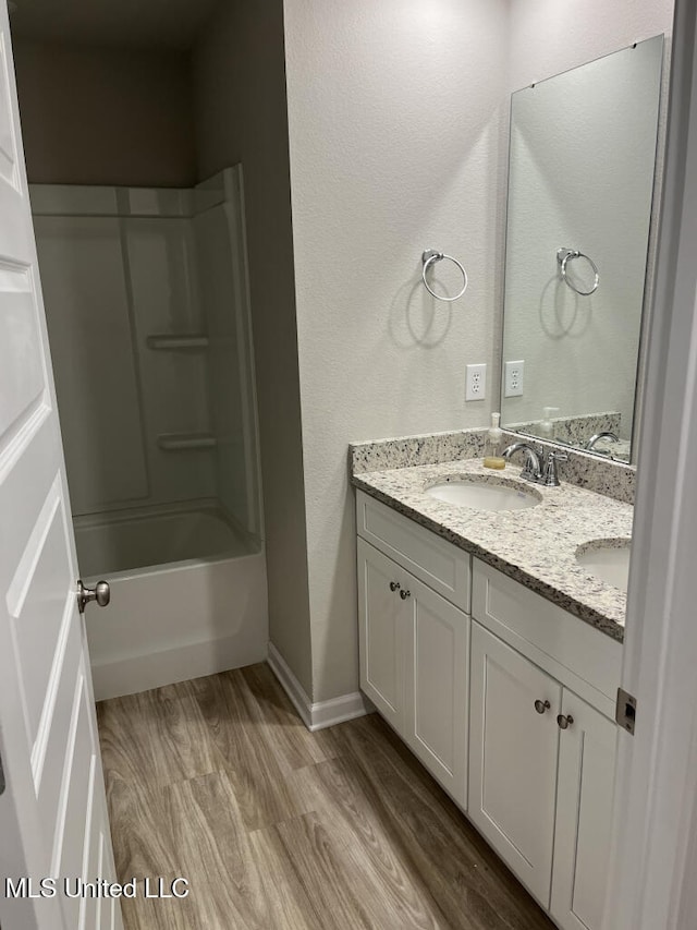 bathroom with vanity, wood-type flooring, and bathing tub / shower combination