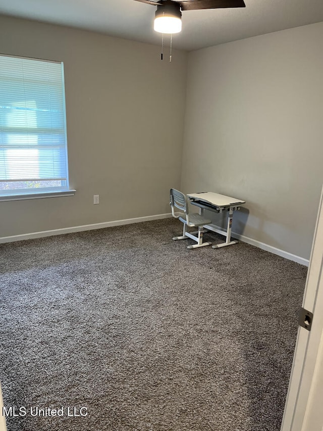 carpeted office space featuring ceiling fan