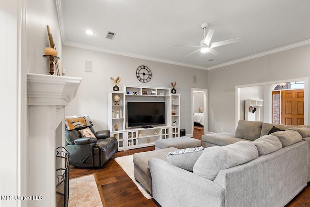 living room with crown molding, dark hardwood / wood-style flooring, and ceiling fan