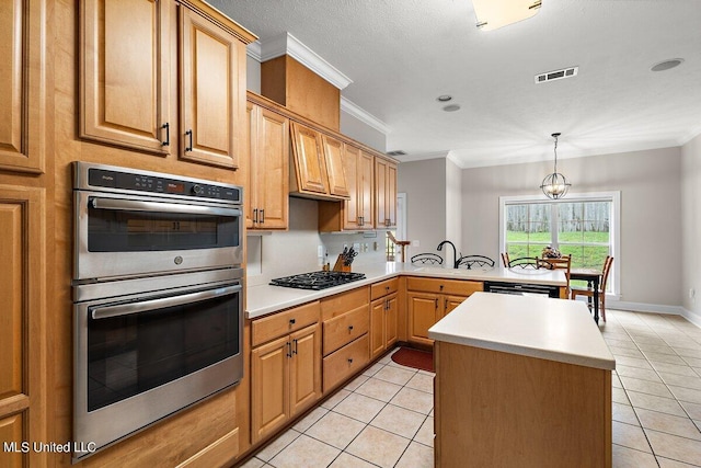 kitchen featuring double oven, gas cooktop, ornamental molding, an inviting chandelier, and light tile patterned floors