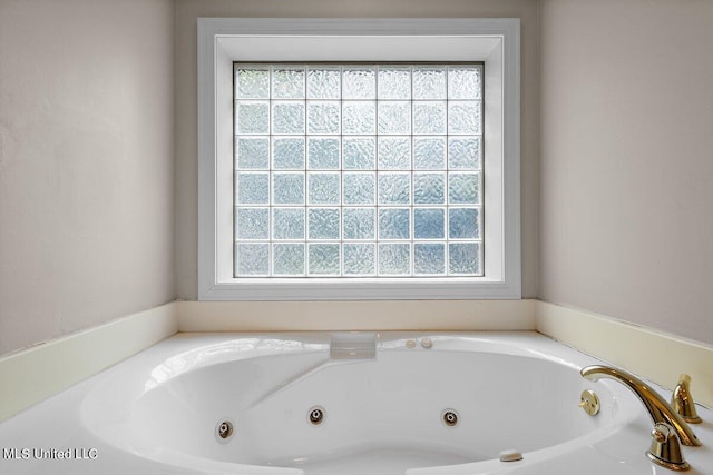 bathroom featuring a bathtub and a wealth of natural light