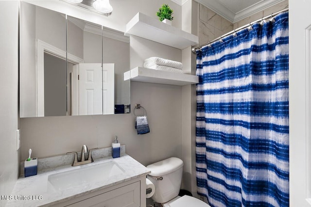 bathroom with vanity, ornamental molding, toilet, and walk in shower