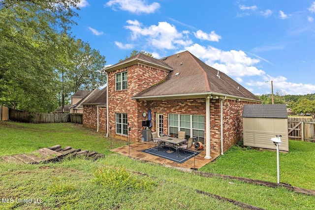 back of property featuring a patio, a storage shed, and a lawn