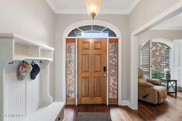 foyer entrance with dark wood-type flooring and ornamental molding