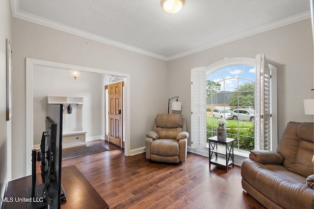 living area featuring ornamental molding, a textured ceiling, and dark hardwood / wood-style flooring