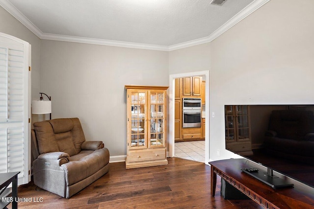 living area featuring a textured ceiling, crown molding, and hardwood / wood-style flooring