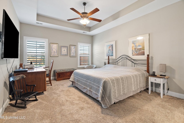 1647 Treestand Rd, Southaven, MS 38672 - bedroom featuring light colored carpet, multiple windows, a tray ceiling, and ceiling fan
